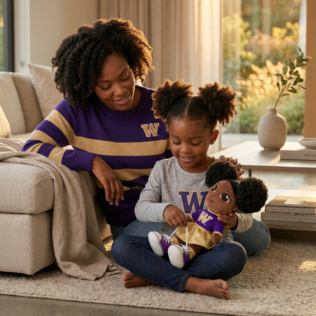 Woman and child sitting on the floor in a living room, holding a toy together.