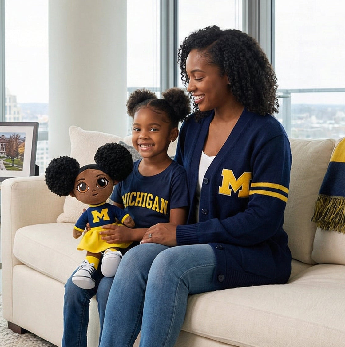 Woman and child sitting on a couch in a modern living room with large windows.