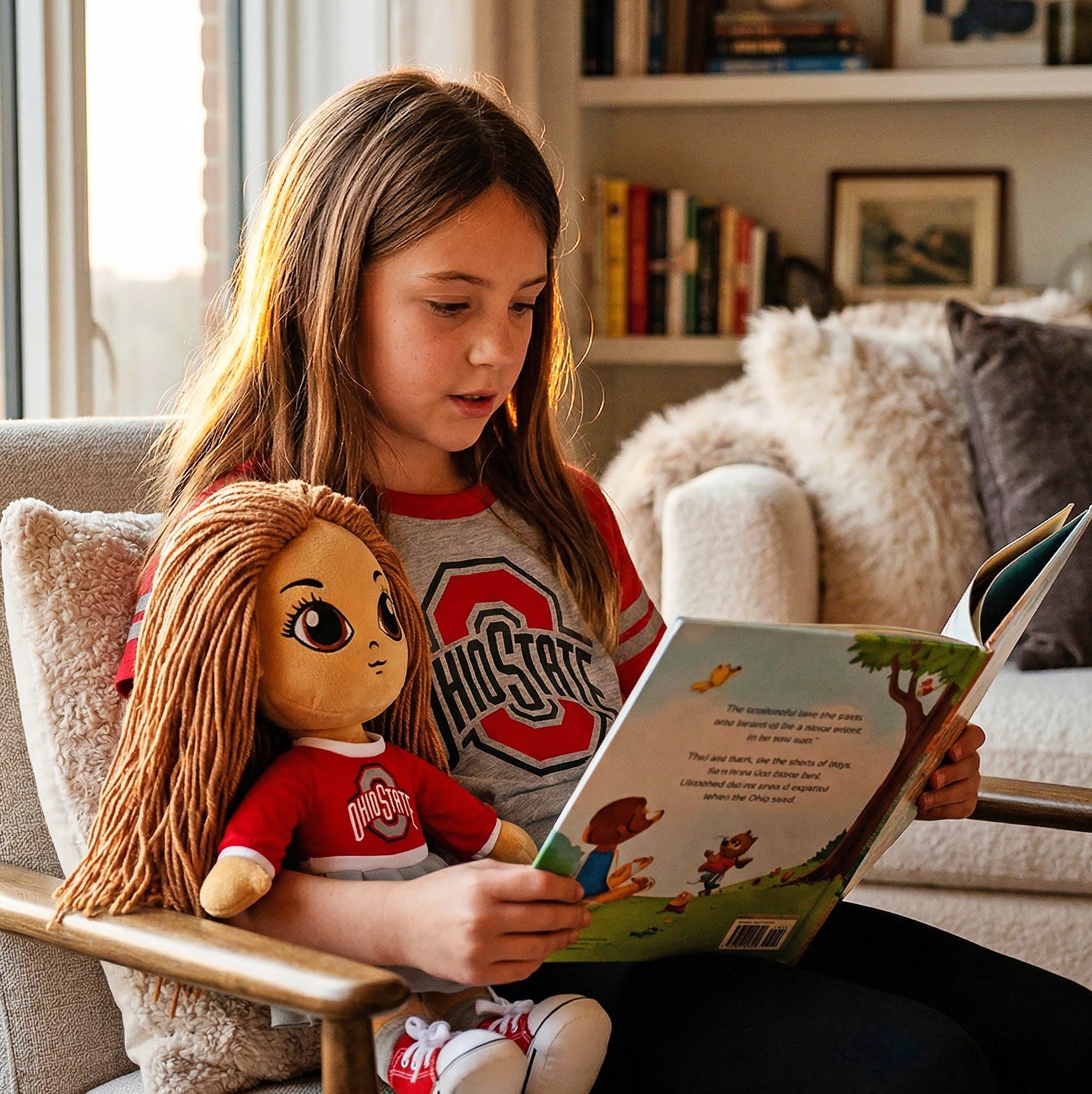 Girl reading a book to a doll in a cozy living room.